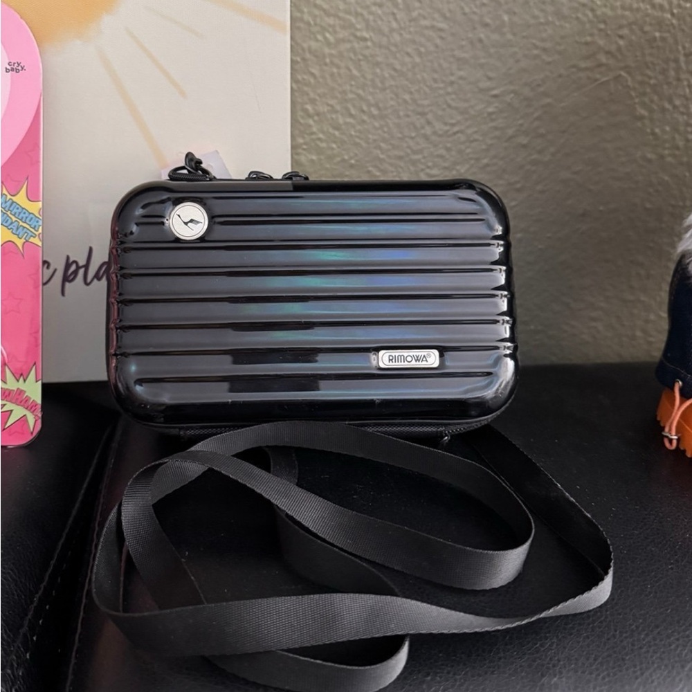 Authentic Rimowa Lufthansa amenity crossbody bag with strap.